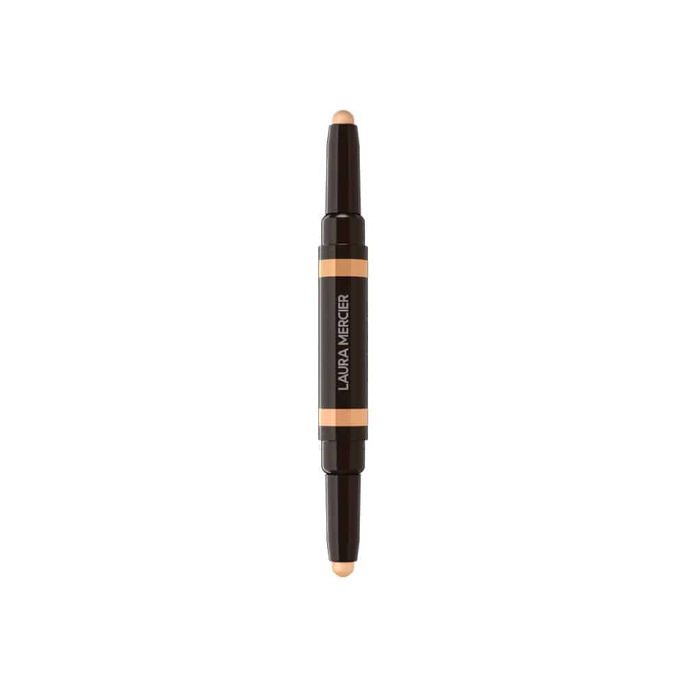 Concealer stick with beige product end, dark body, and orange center label strip
