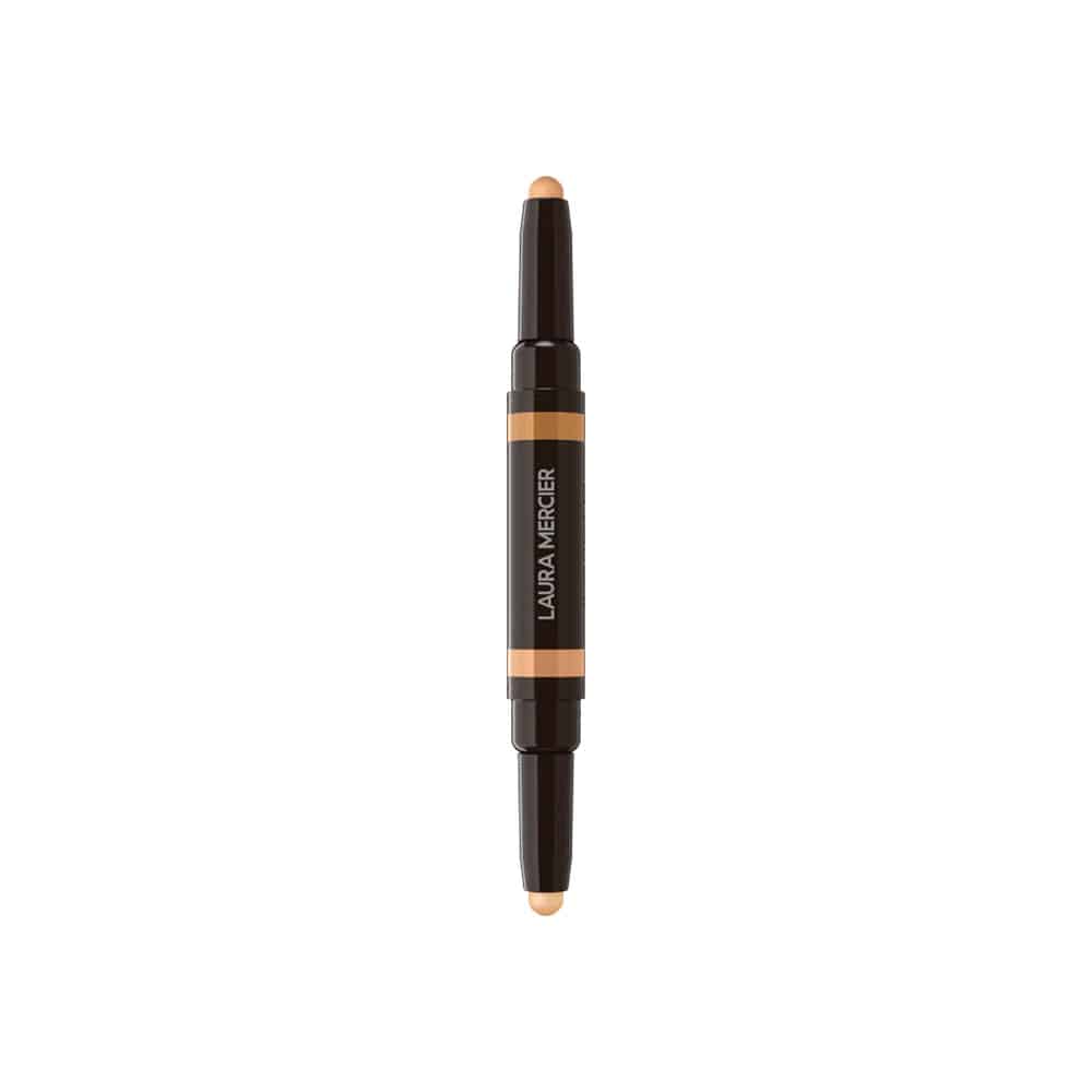 Concealer stick with beige tip, dark cap, and orange label band; screw-top base
