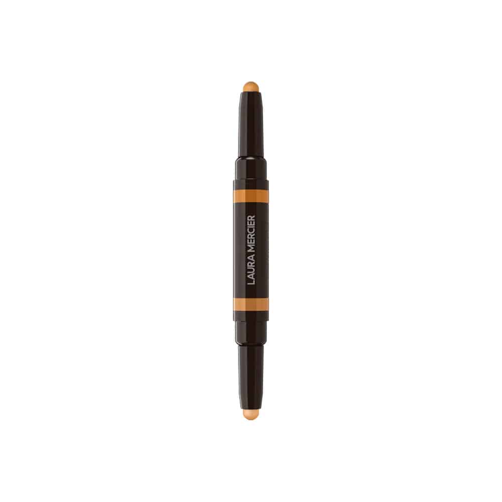 Concealer stick with beige tip and orange label band, dark body and cap