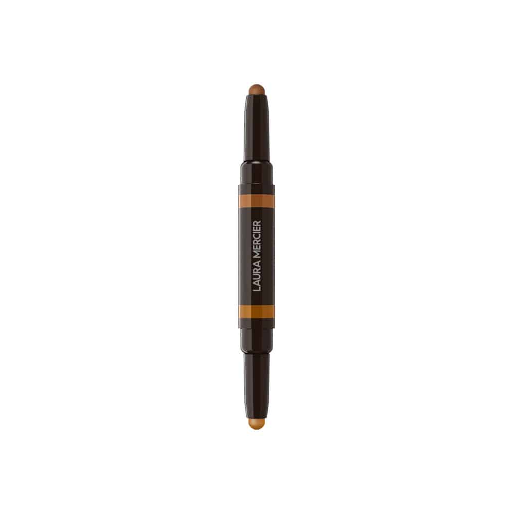 Concealer stick with dark tube, orange label band, and beige product tip