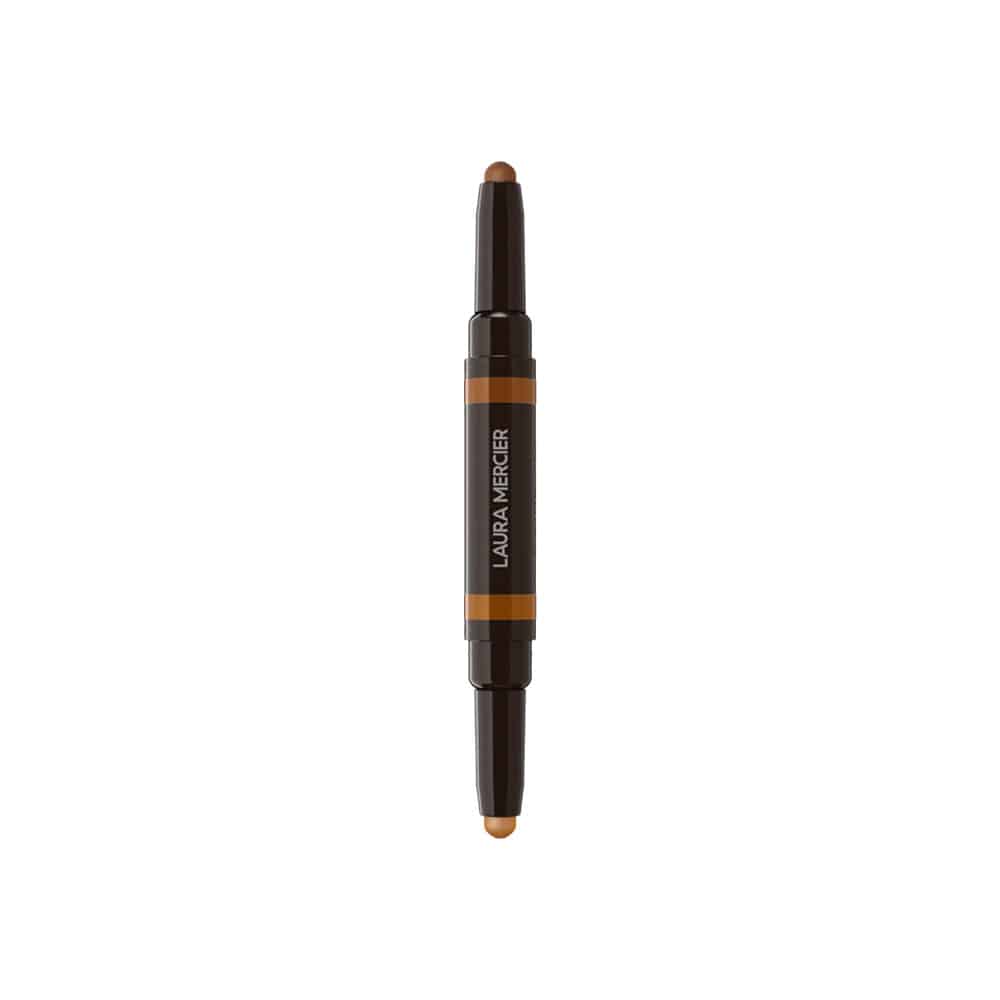 Concealer stick with beige tip, dark cap, and orange center label stripe