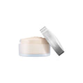Translucent loose setting powder jar with silver-gray cap and light powder layer