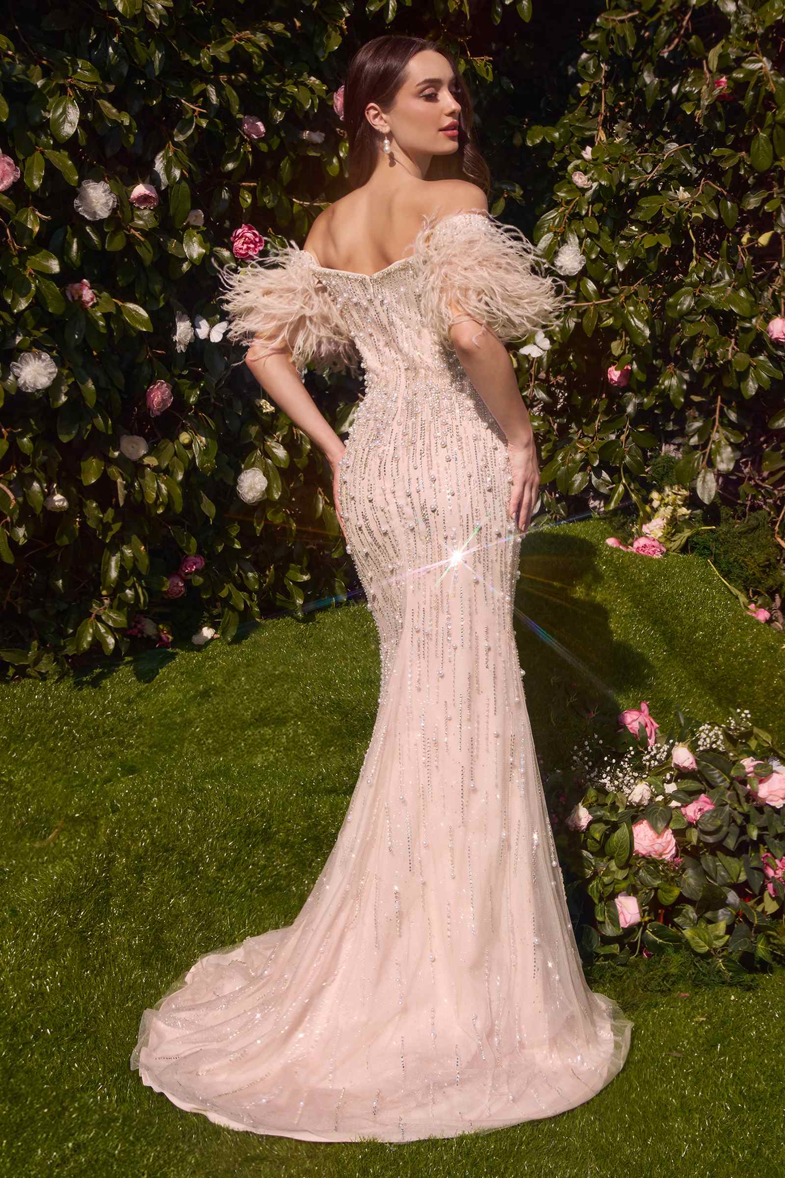 Rose champagne strapless pearl gown with feather sleeves and long train