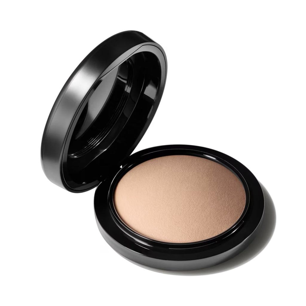 Face powder compact with open lid and light beige powder pan