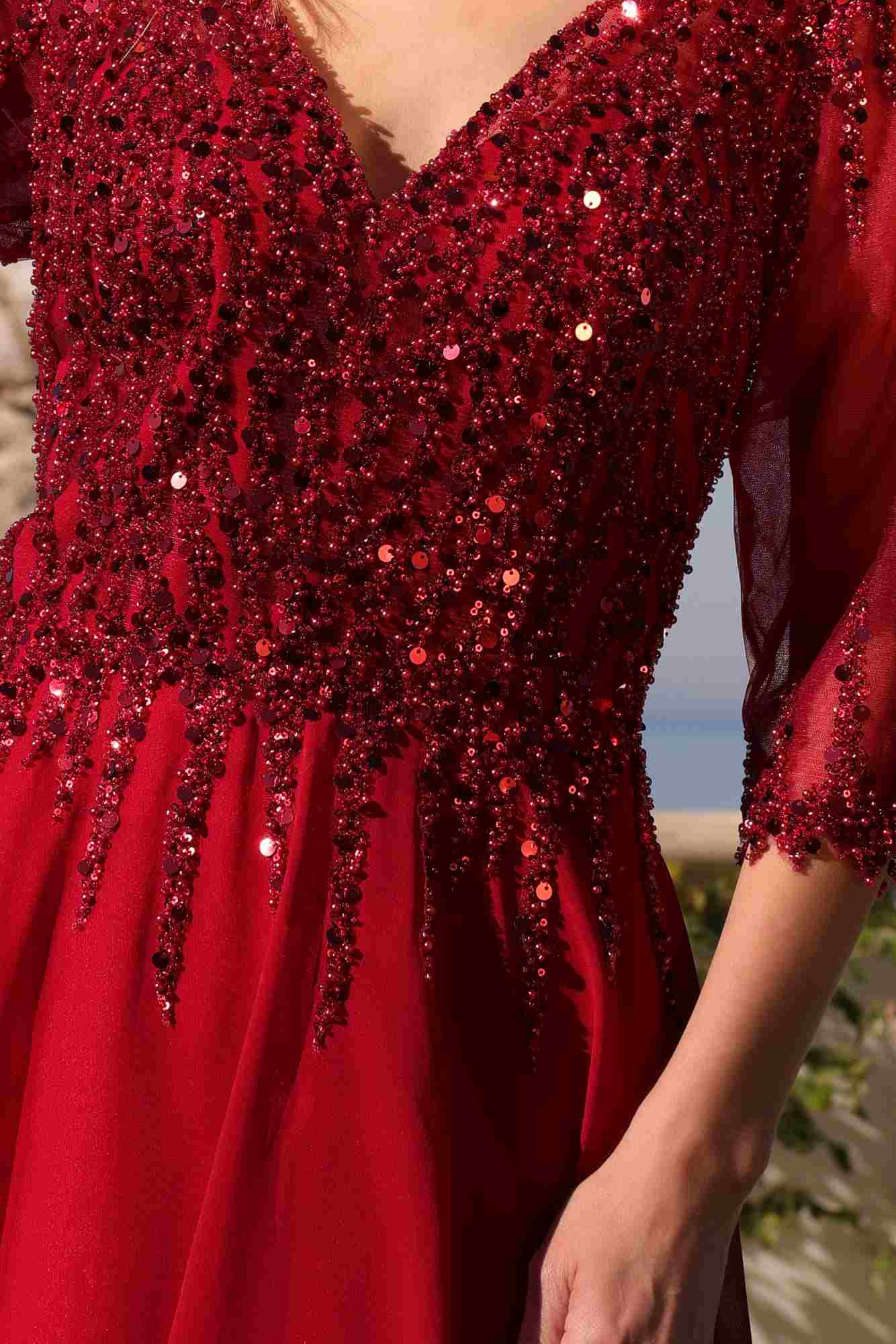 Burgundy sequined bodice with V-neck and elbow-length sleeves