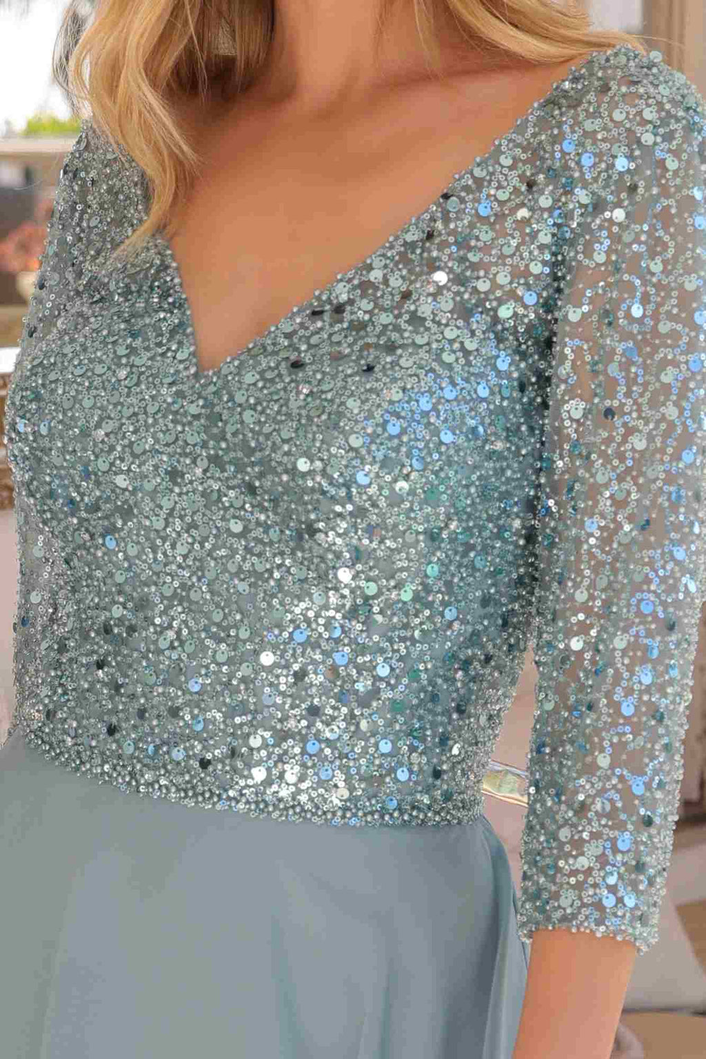 Sea blue sequin bodice with V neckline and 3/4 sleeves, close-up