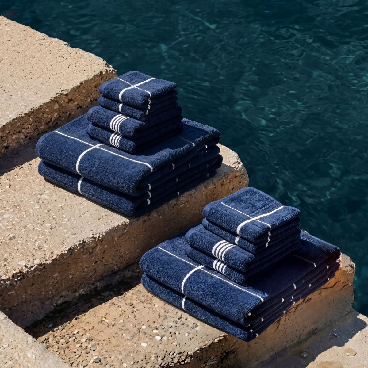 Navy and white striped cotton towels, neatly stacked on a ledge