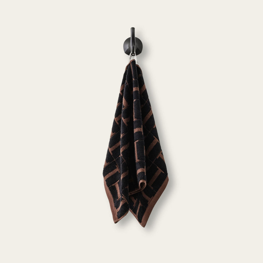 Hanging cotton hand towel with tobacco and black geometric woven design