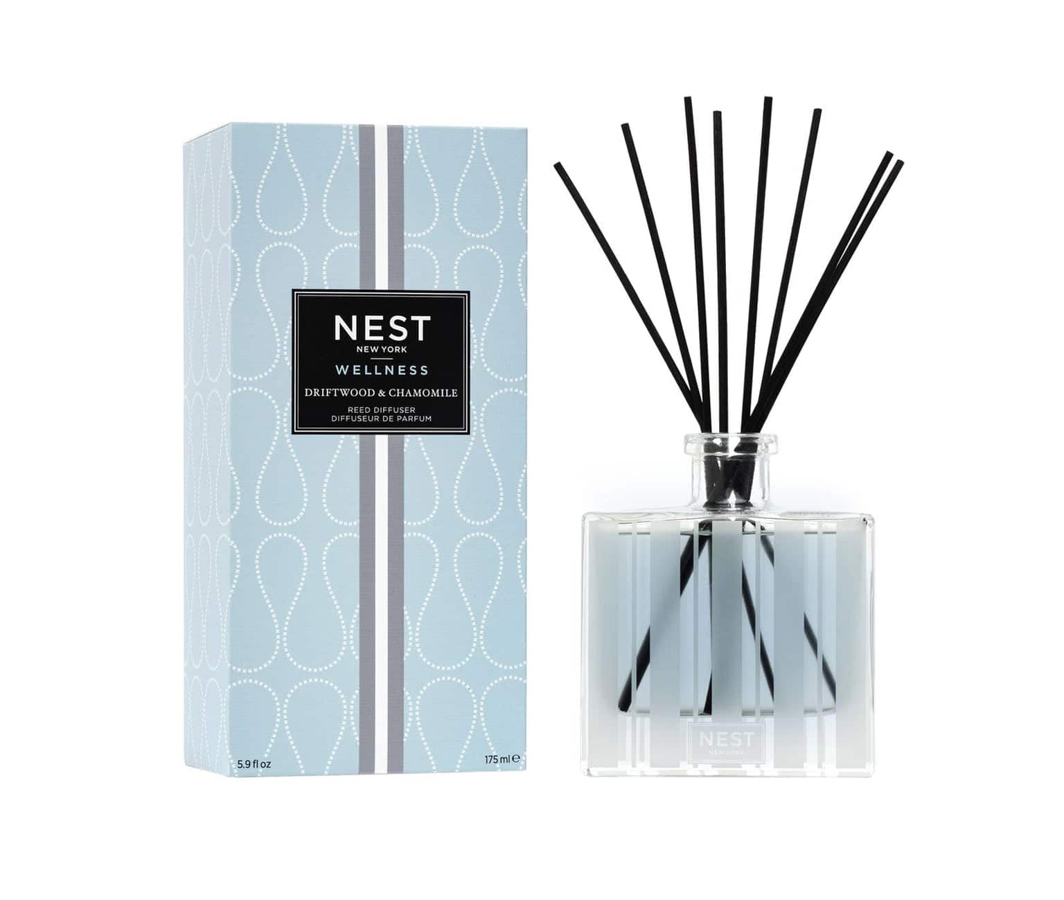 Scent diffuser set with NEST branding, clear glass bottle and black reeds