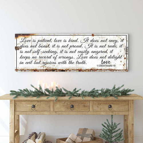 Rustic wall sign with brown distressed frame and white script verse on dark background.