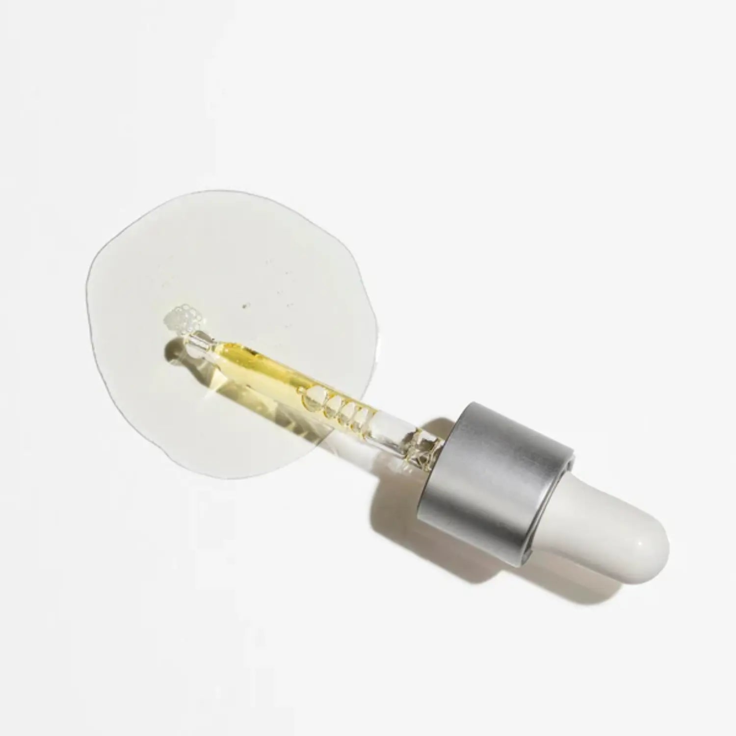 Antioxidant serum dropper with clear/yellow serum liquid and silver metal tip