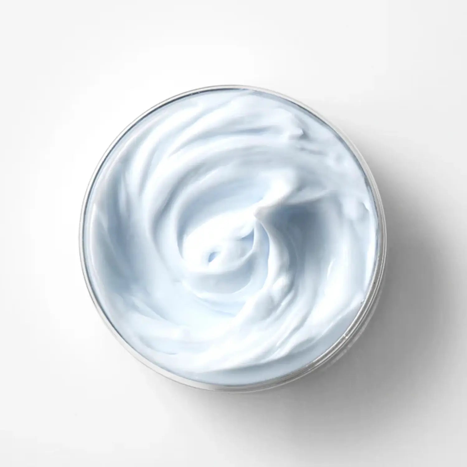 Open cream jar with smooth white cream texture inside a round container