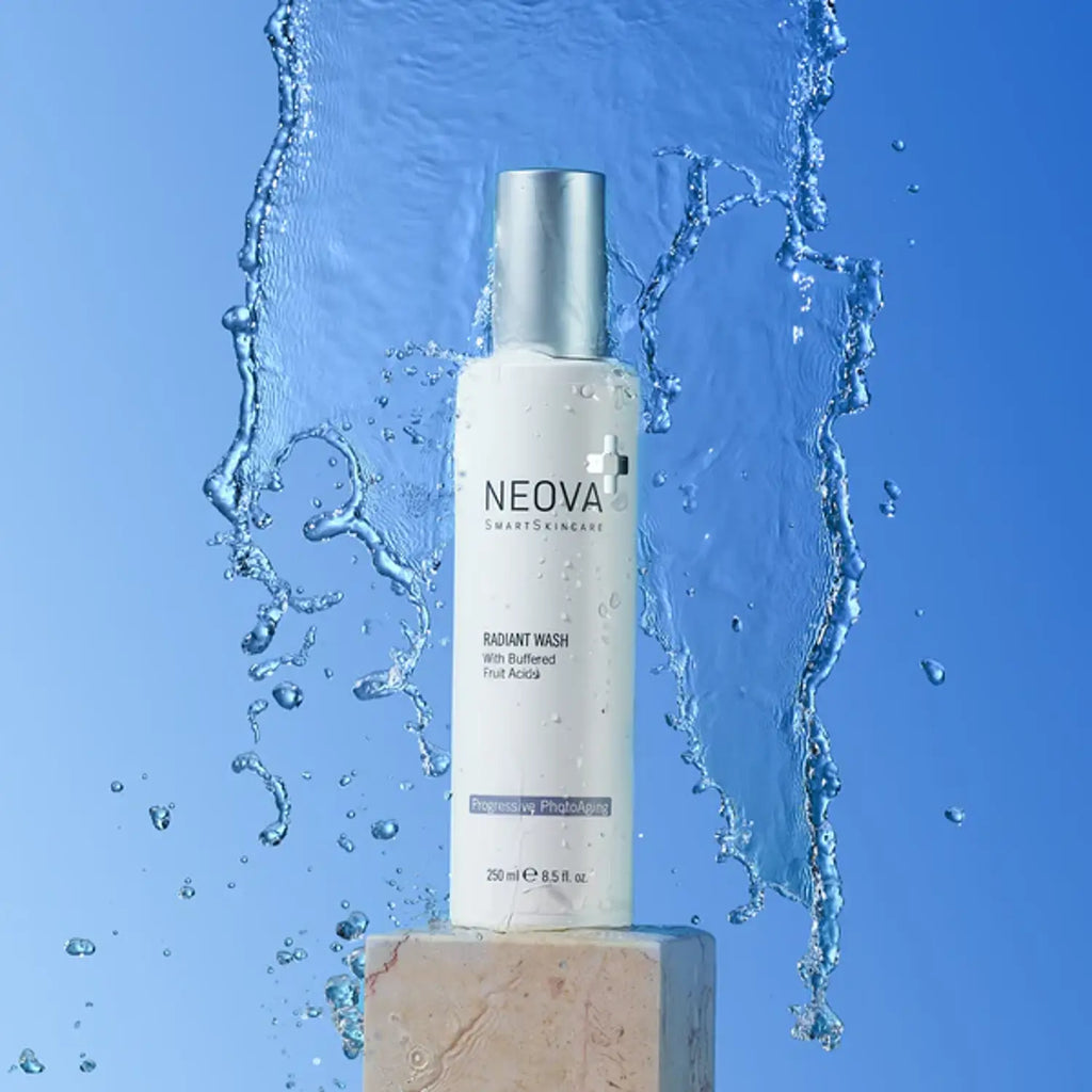 Radiant Wash bottle with silver pump cap, shown with splash of water