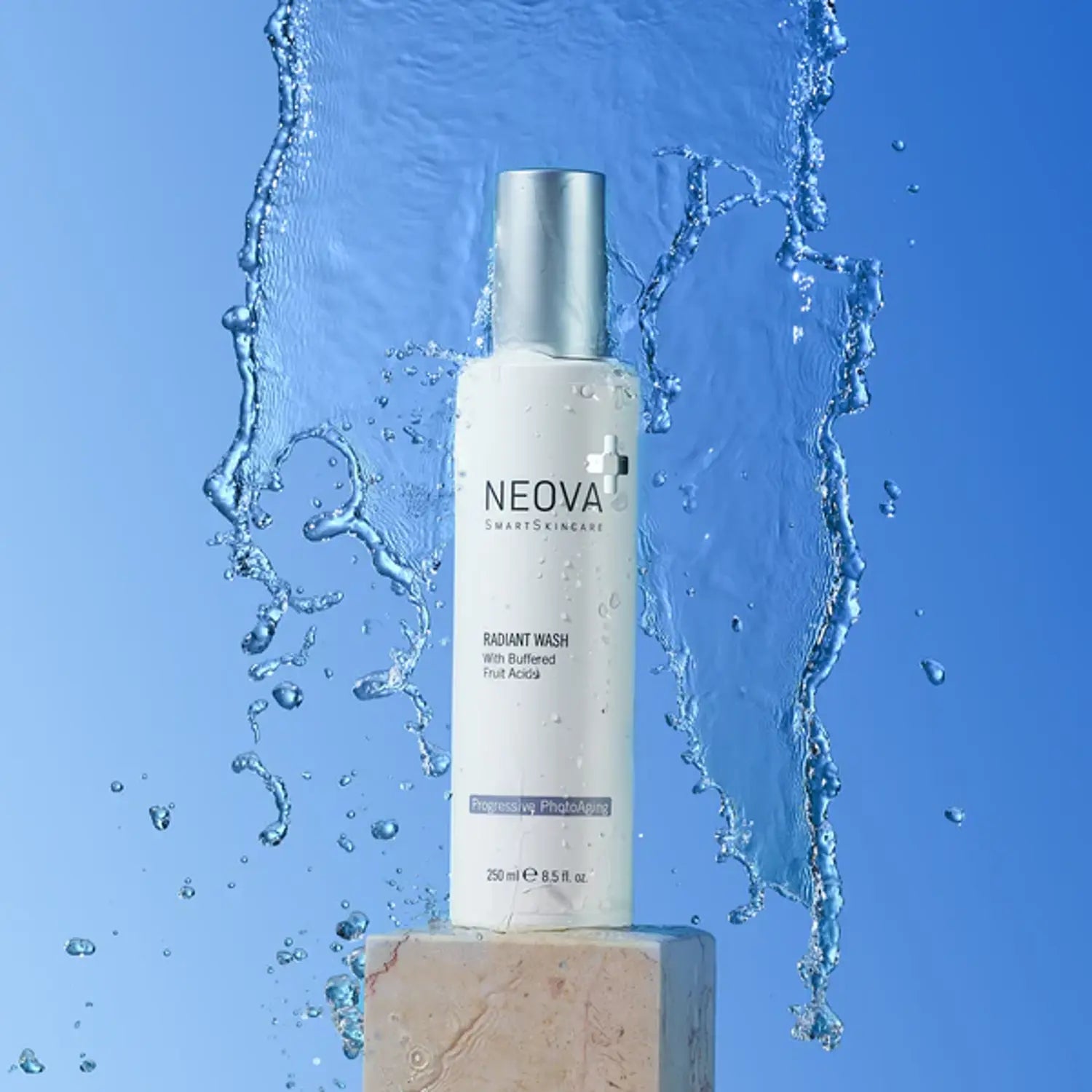 Radiant Wash bottle with silver pump cap, shown with splash of water