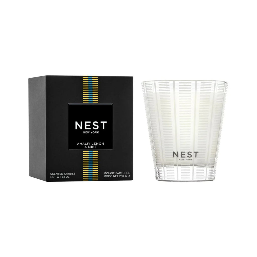 Ribbed white glass candle with NEST label, shown with matching box