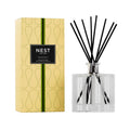 Grapefruit reed diffuser in clear glass bottle with black reeds and gold patterned box