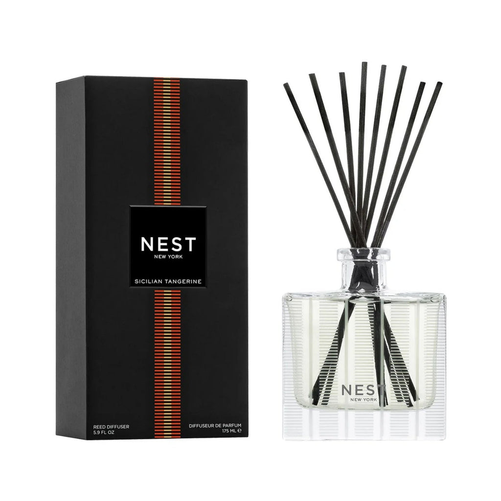 Reed diffuser set with clear glass bottle, black reeds, and NEST Sicilian Tangerine box