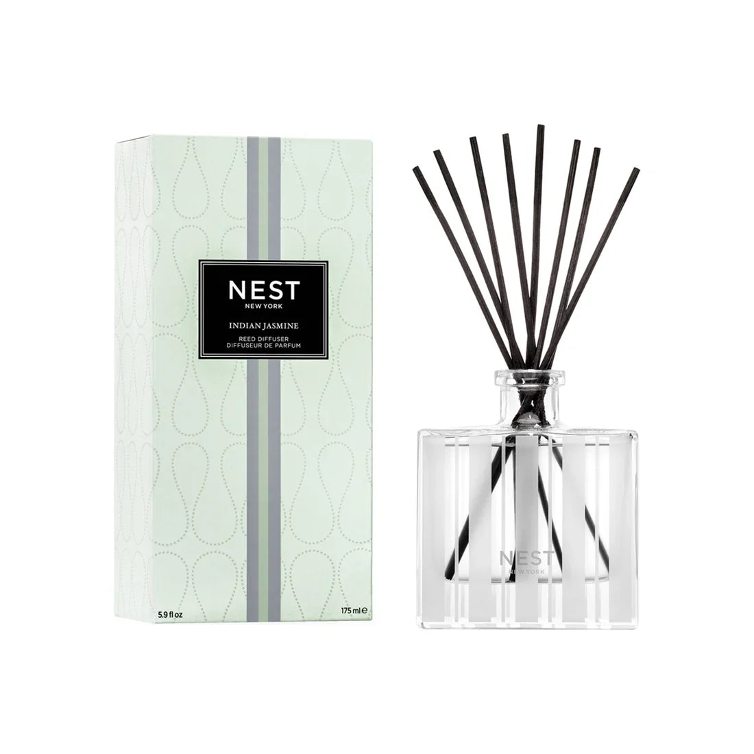 Reed diffuser set with clear glass bottle, black reeds, and Nest Indian Jasmine label