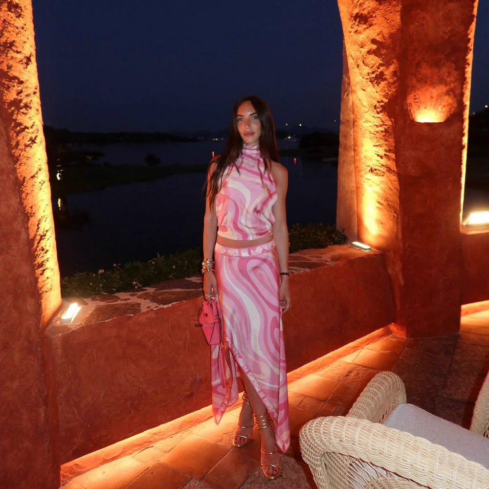 Pink printed satin halter backless crop top with high-slit asymmetric maxi skirt