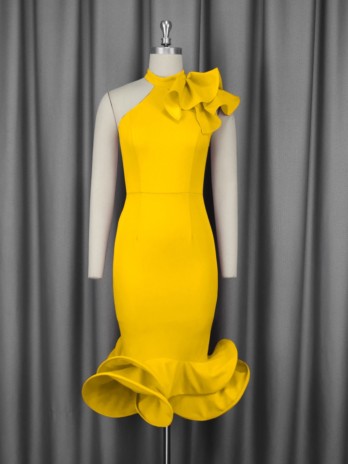 Yellow fitted cocktail dress on mannequin with ruffled collar and layered flared hem
