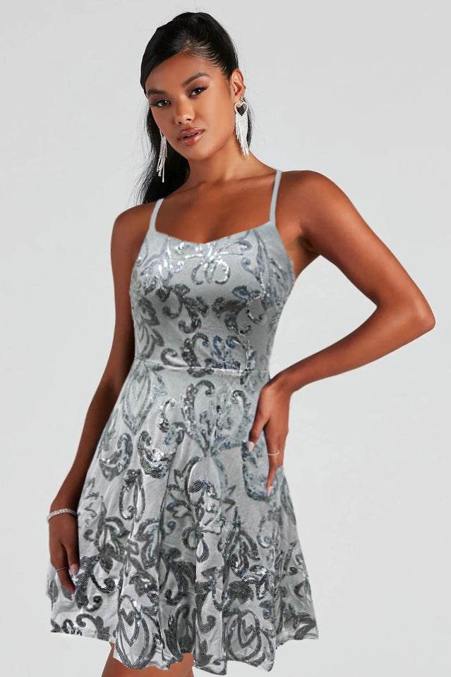 Gray-silver sequin mini dress with spaghetti straps and gathered flared skirt.