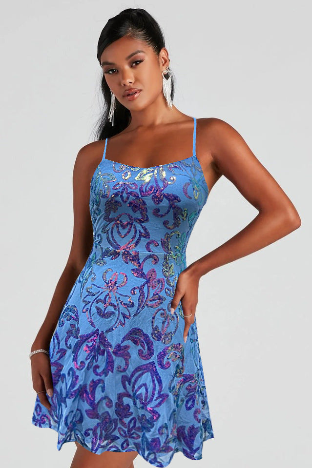 Blue patterned sequin mini dress with spaghetti straps and flared skirt hem.