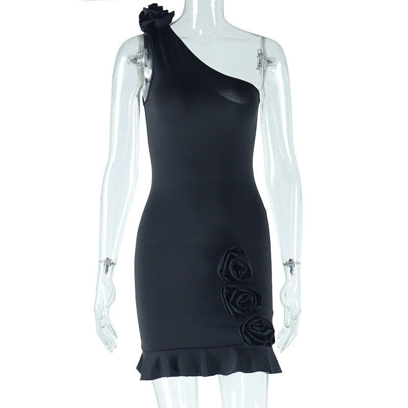 Black sleeveless fitted mini sheath dress with diagonal neckline and rose appliques