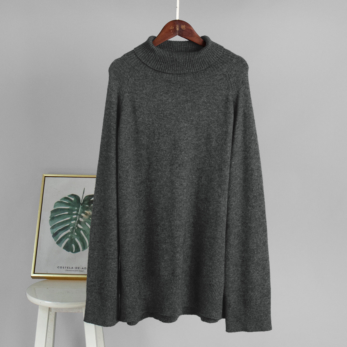 Dark gray turtleneck knit sweater on hanger with ribbed neckline
