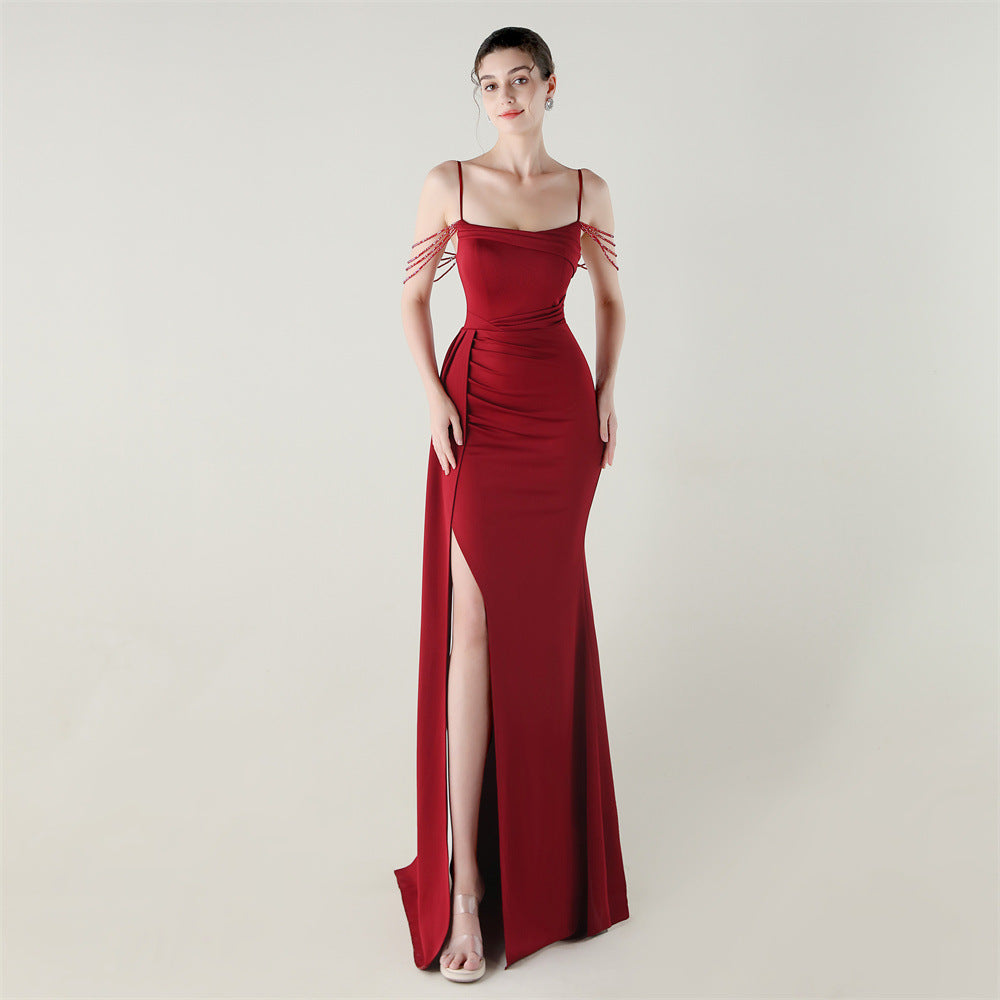 Burgundy satin evening dress with spaghetti straps, beaded fringe shoulders, and side slit