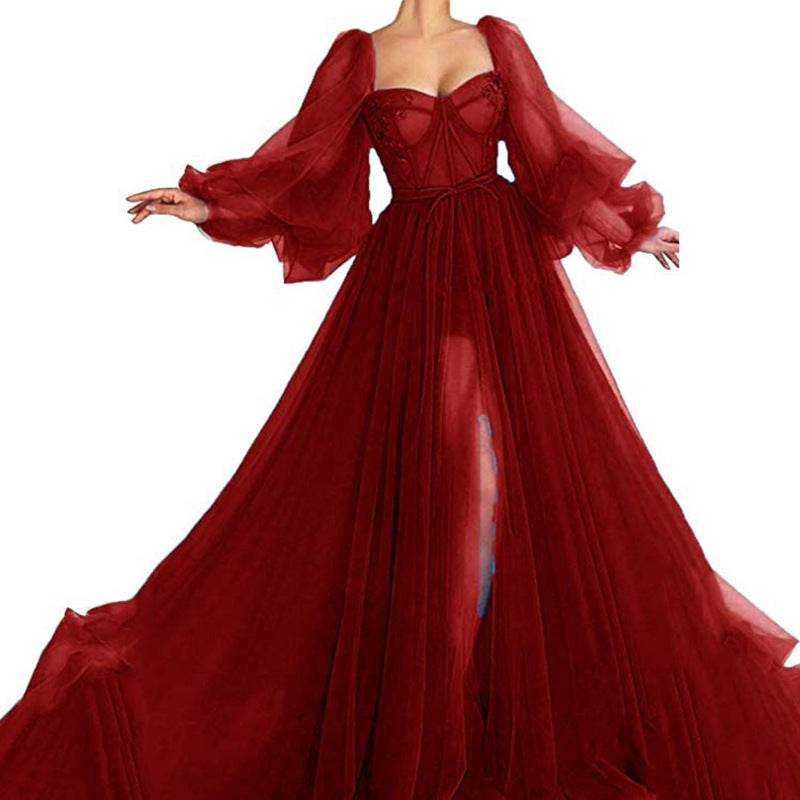 Red mesh corset-style maxi dress with sheer puff sleeves and front slit