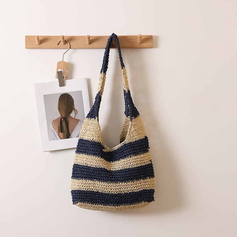 Striped crochet straw shoulder bag with navy and beige horizontal bands, wide open top