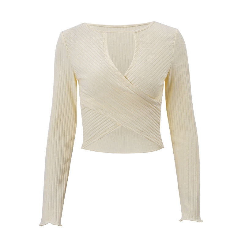 Beige ribbed knit wrap cropped top with long sleeves and V neckline cutout