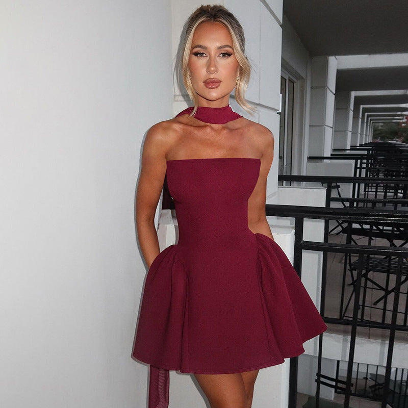 Women’s sleeveless burgundy flare mini dress with high halter neck and pleated skirt