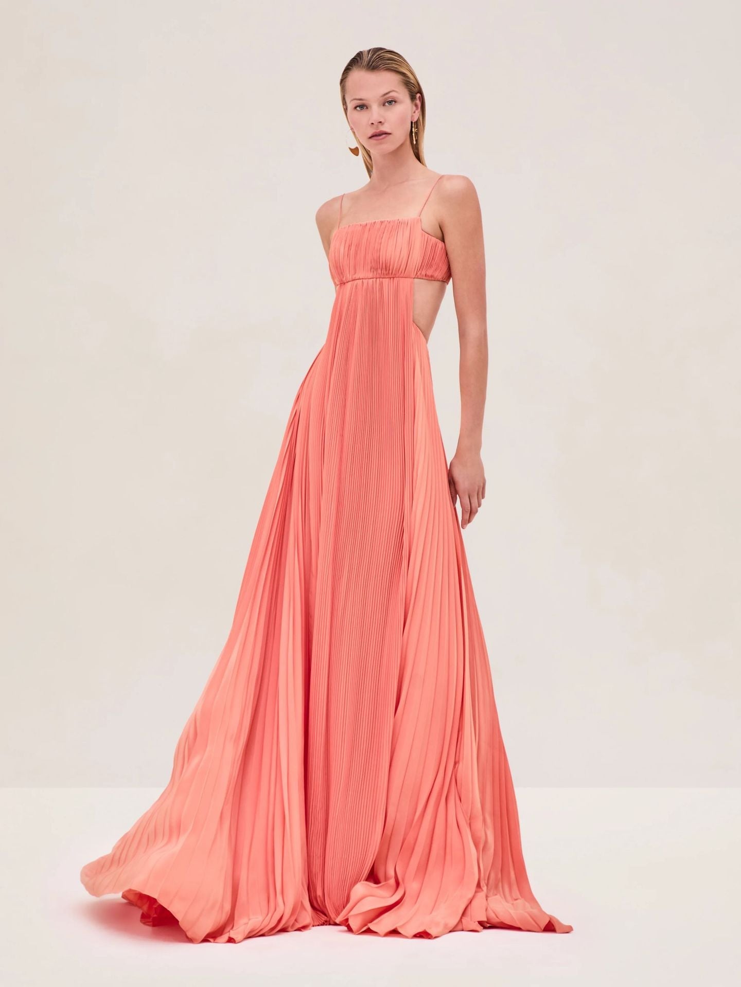 Coral pleated maxi dress with smocked bandeau top and flowing skirt