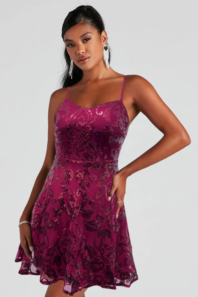 Burgundy sequin mini dress with spaghetti straps and flared skirt hem.