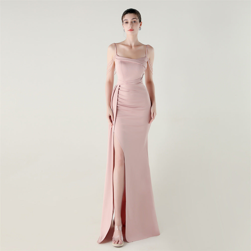 Blush pink satin evening dress with thin straps, ruched bodice, and side slit