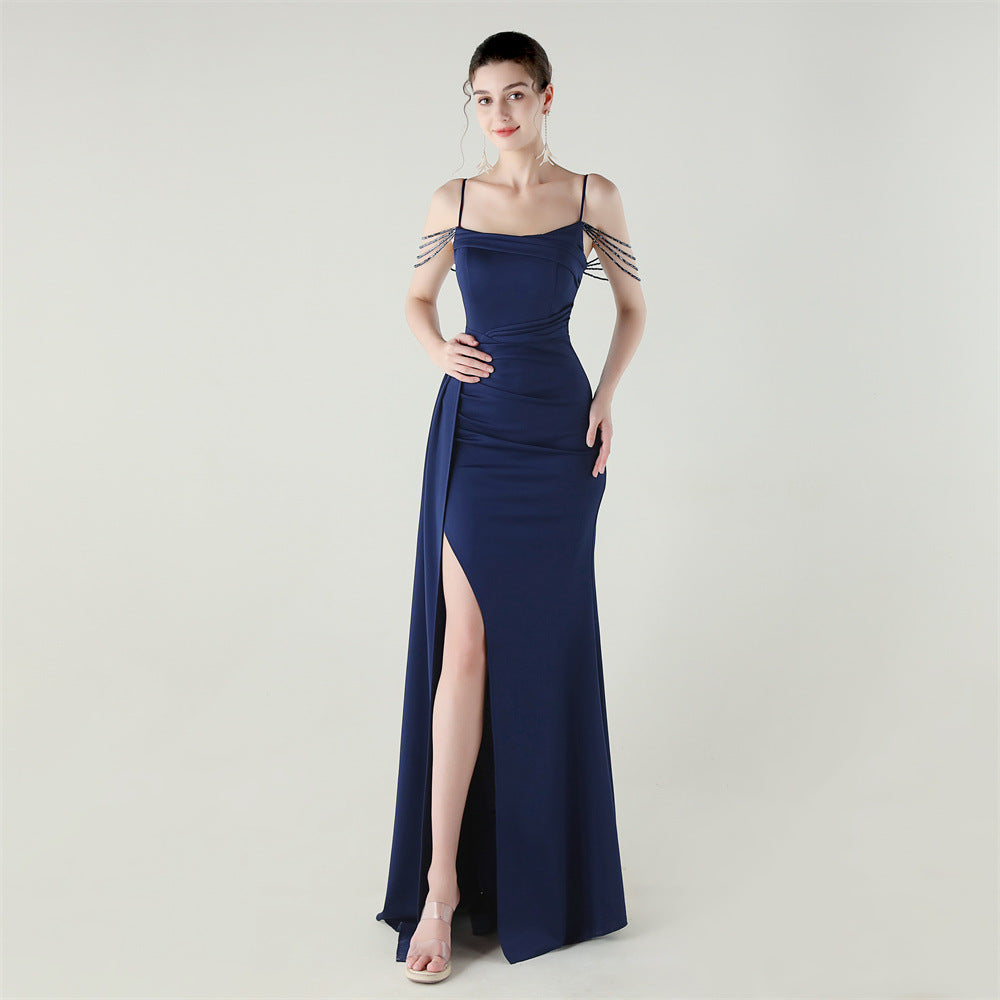 Navy satin evening dress with thin straps, ruched waist, and thigh-high slit