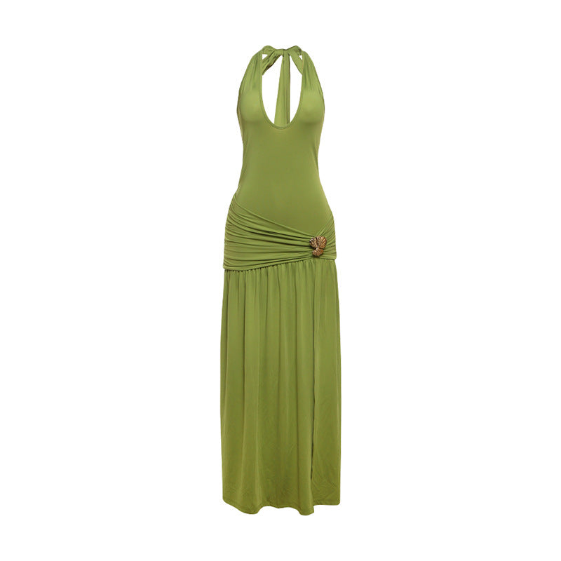 Green open-back halter maxi dress with ruched waist and long flowing skirt