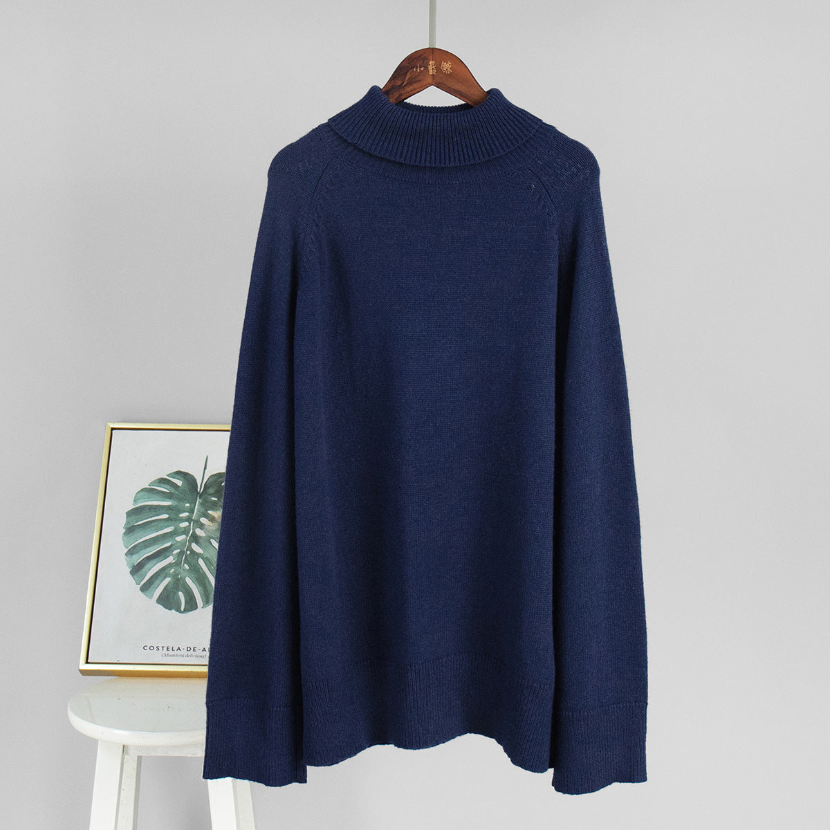Navy turtleneck sweater with ribbed collar and cuffs, long sleeves