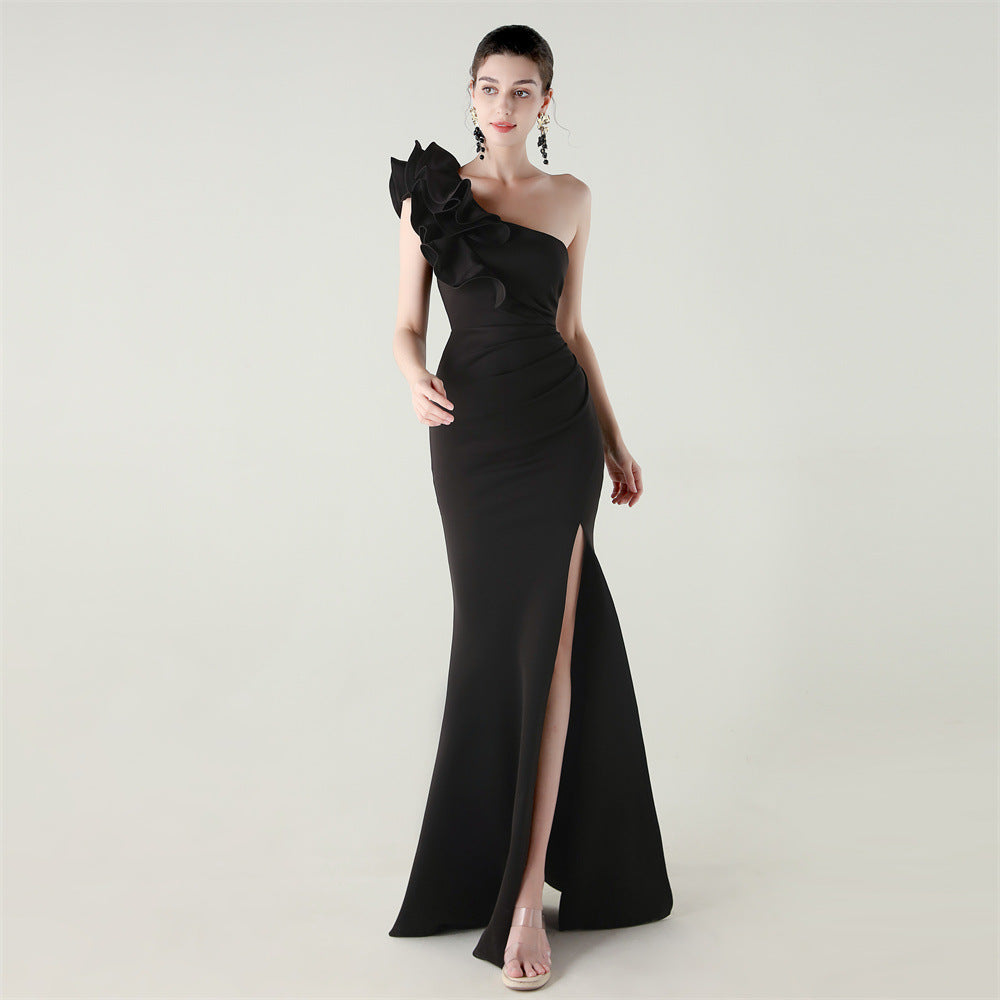 Black one-shoulder satin evening dress with ruffle shoulder detail and high slit