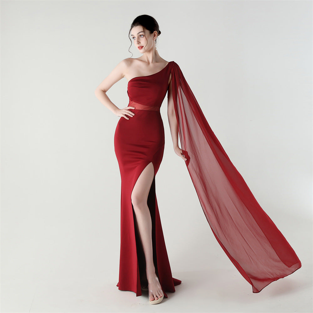 Single-shoulder satin slim cocktail dress with thigh slit and sheer mesh drape, red.