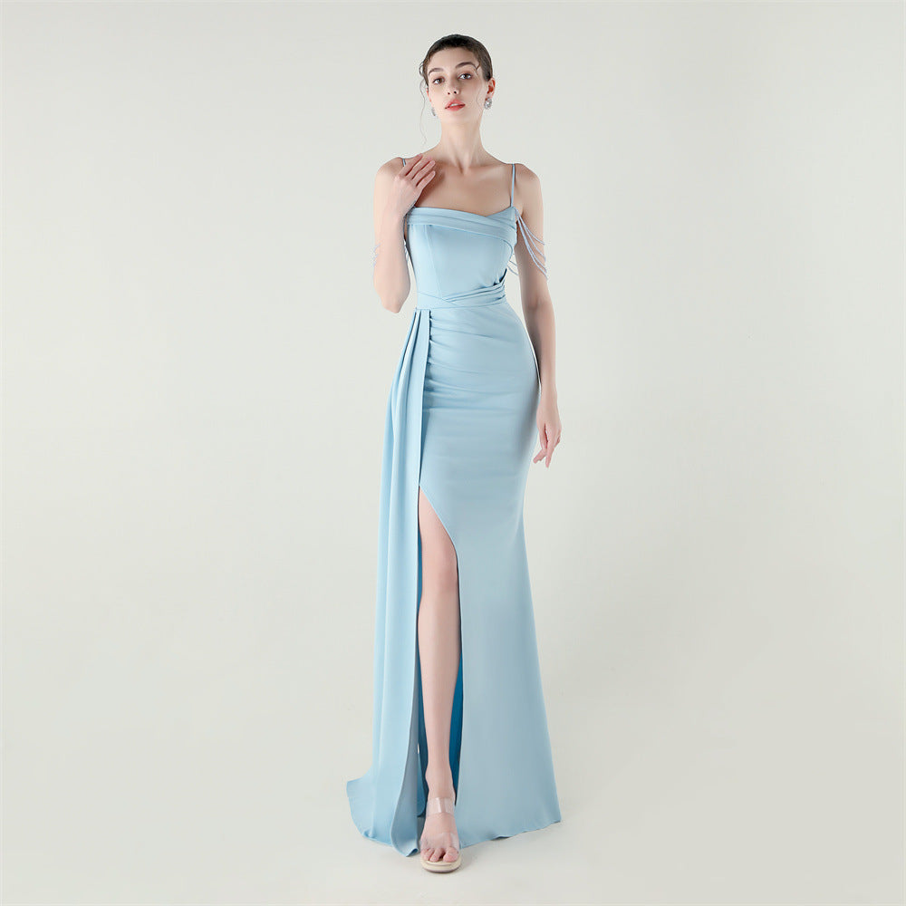 Light blue satin evening dress with spaghetti straps, beaded fringe sleeves, and thigh slit