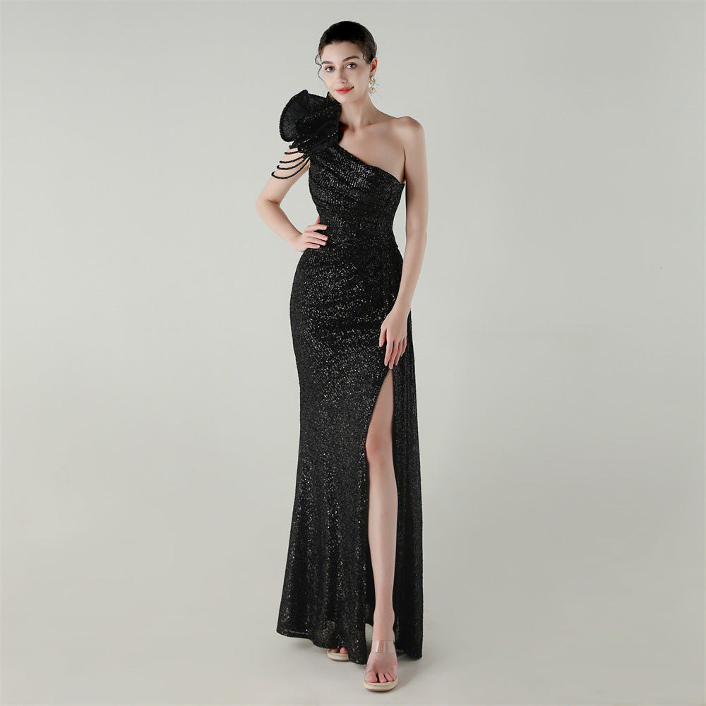 Black one-shoulder beaded evening gown with diagonal neckline and side slit fishtail hem