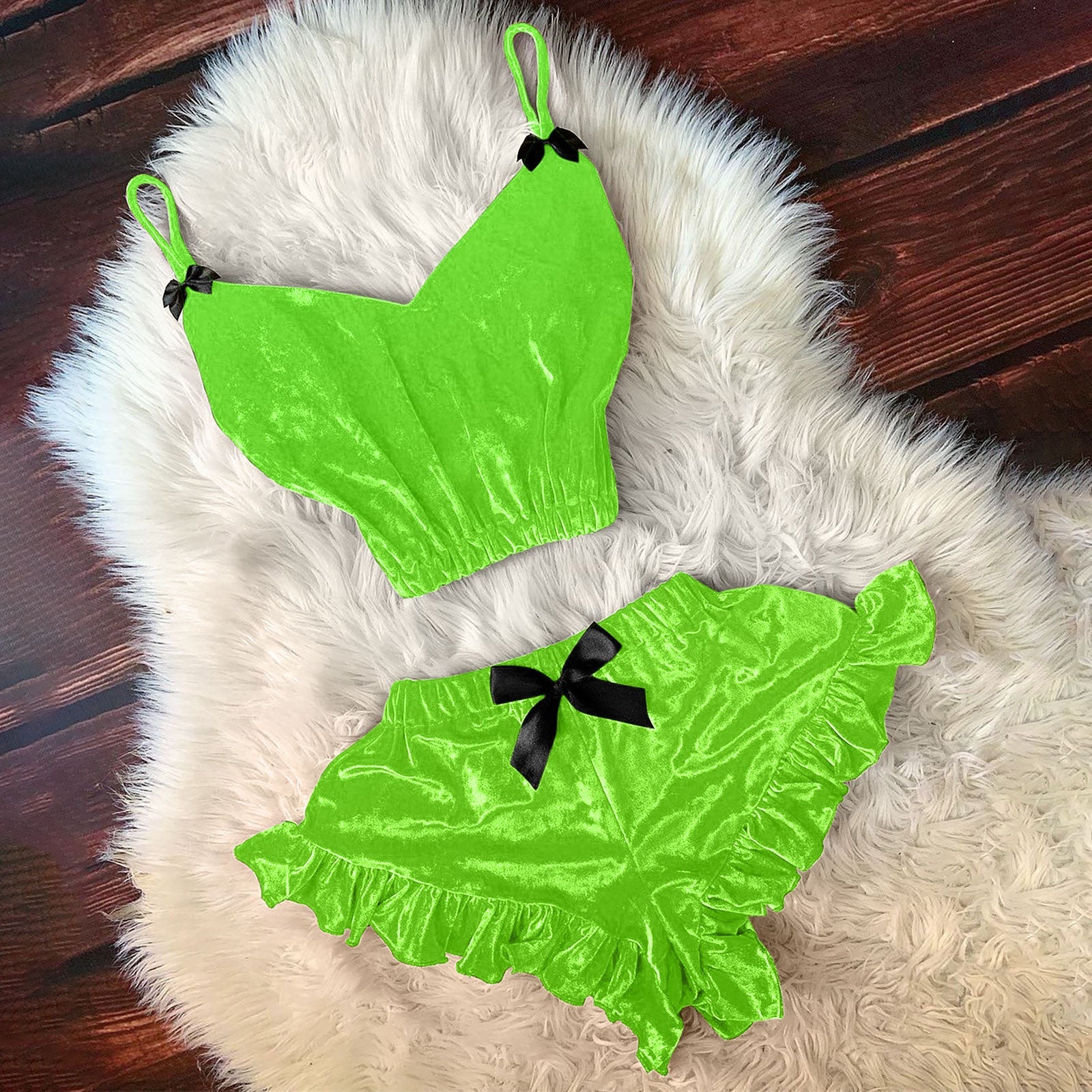 Neon green satin cami with black bow and ruffle hem shorts, matching two-piece set