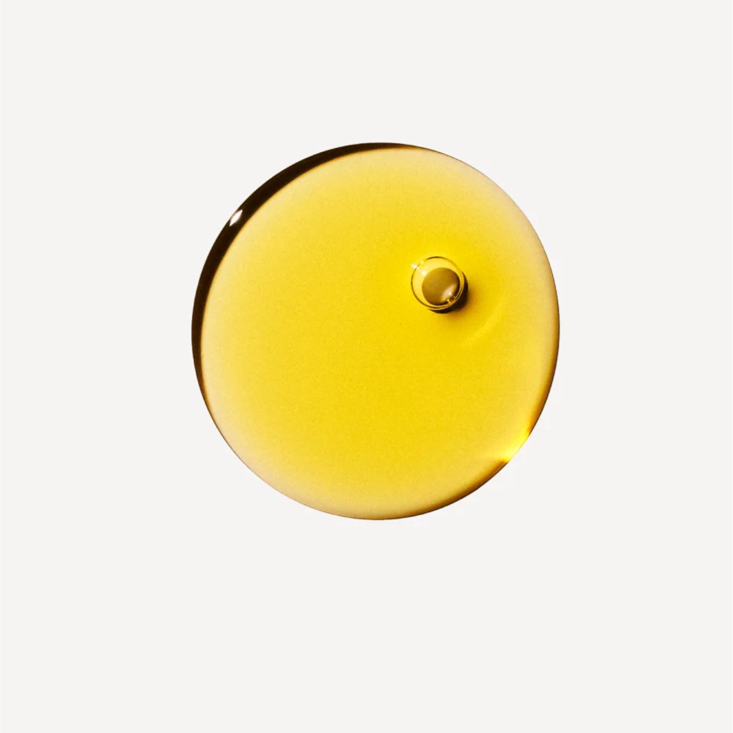 Olaplex No. 7 Bonding Oil cap, round golden lid with small center button