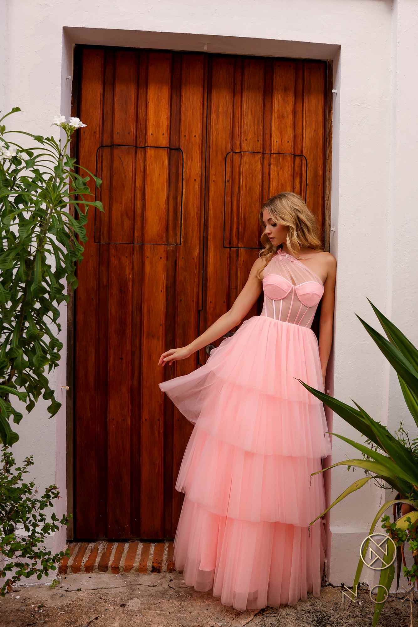 Pink layered tulle ball gown with corset-style bodice and voluminous tiered skirt