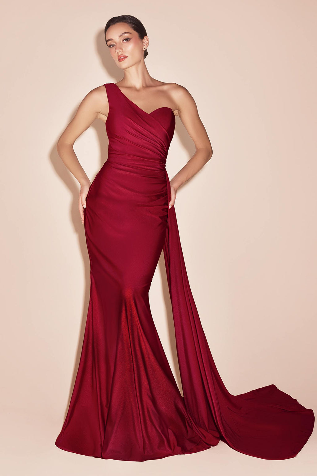 One-shoulder satin gown in deep red with gathered waist and draped side sash, long skirt