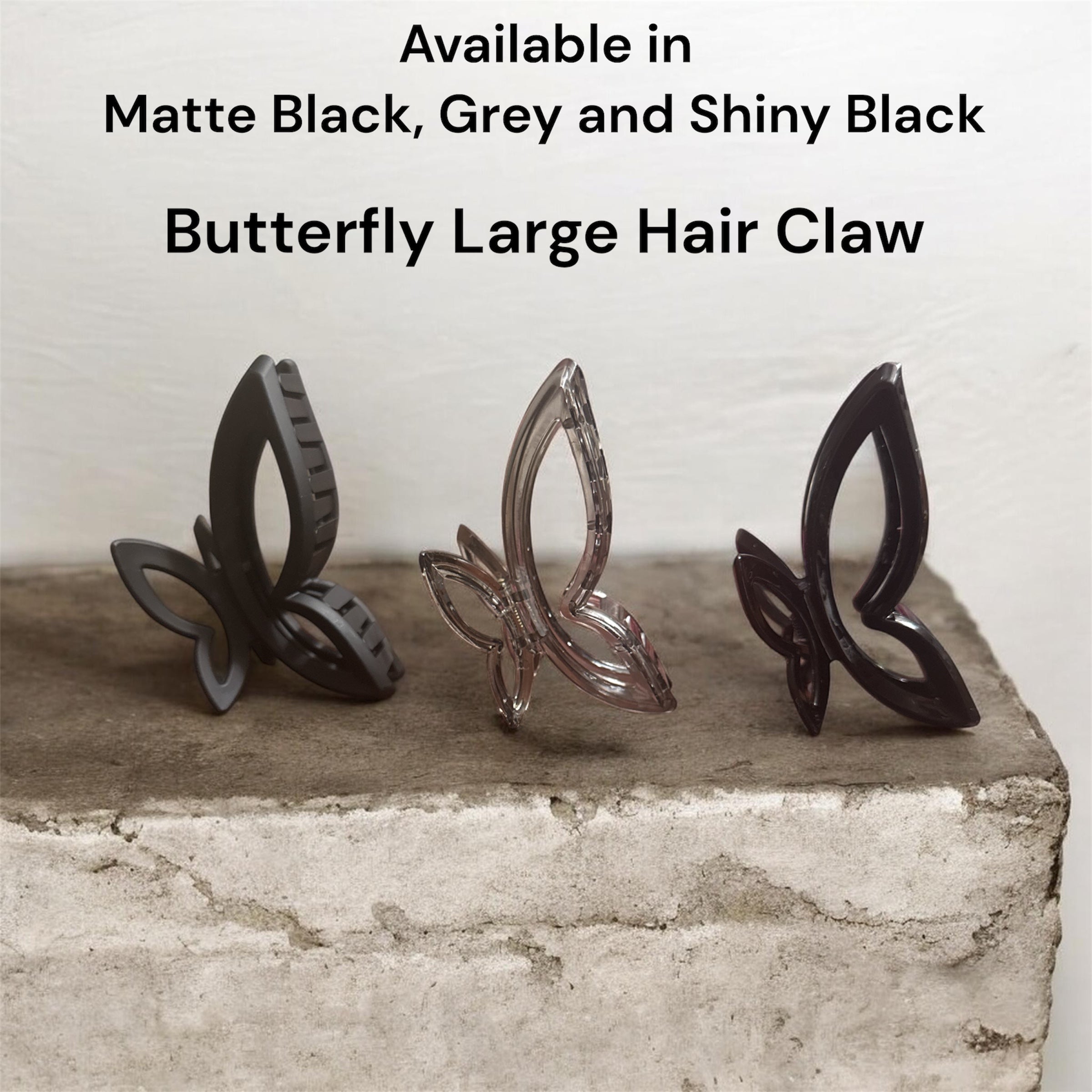 Large butterfly hair claw in matte black and clear, curved gripping teeth