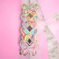 Butterfly hair accessory storage with clear clips holding colorful hair ties