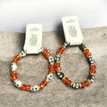 Skull bead stretch bracelet with amber orange glass beads and white skull charms